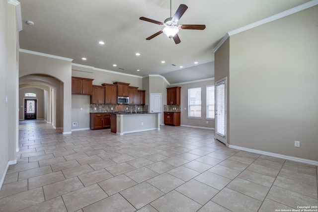 12418 Maverick Rnch, San Antonio, TX 78254 - kitchen with stainless steel microwave, crown molding, open floor plan, dark countertops, and a ceiling fan