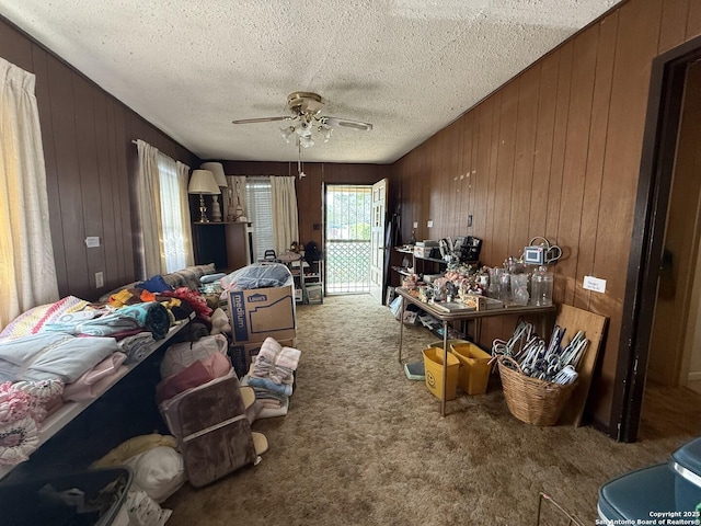 318 Uvalde, San Antonio, TX 78210 - carpeted bedroom with wooden walls, access to outside, and a textured ceiling