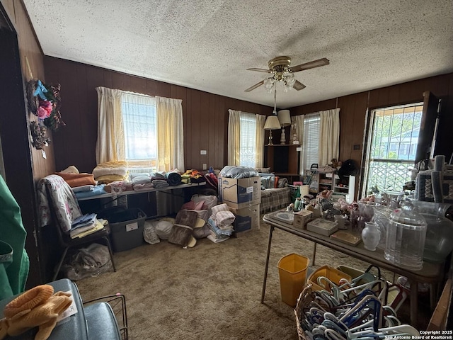 318 Uvalde, San Antonio, TX 78210 - carpeted dining space with a ceiling fan, wood walls, and a textured ceiling