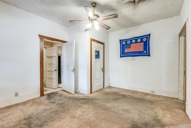 806 Kayton Ave, San Antonio, TX 78210 - unfurnished bedroom featuring carpet, a textured ceiling, baseboards, and a ceiling fan