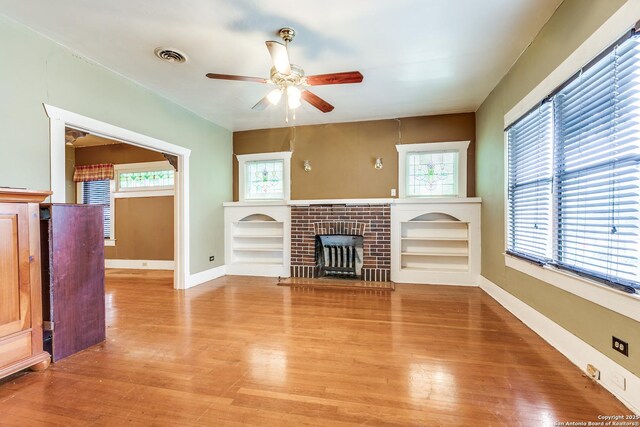 806 Kayton Ave, San Antonio, TX 78210 - unfurnished living room with ceiling fan, light wood-style flooring, a fireplace, and baseboards