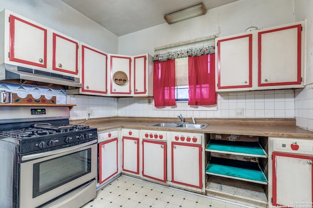 806 Kayton Ave, San Antonio, TX 78210 - kitchen featuring stainless steel range with gas cooktop, under cabinet range hood, a sink, light flooring, and tasteful backsplash