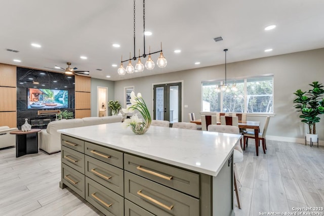 7812 Ventura Blvd, Selma, TX 78154 - kitchen with light wood-type flooring, recessed lighting, a center island, ceiling fan, and gray cabinets