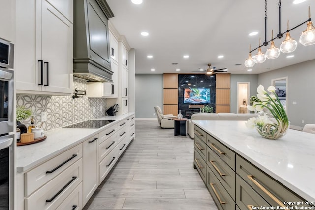 7812 Ventura Blvd, Selma, TX 78154 - kitchen with black electric stovetop, open floor plan, light stone counters, a ceiling fan, and tasteful backsplash
