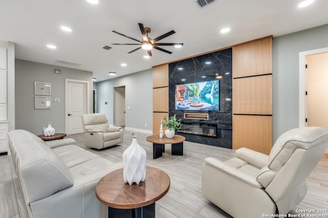 7812 Ventura Blvd, Selma, TX 78154 - living area with ceiling fan, recessed lighting, a large fireplace, baseboards, and light wood finished floors