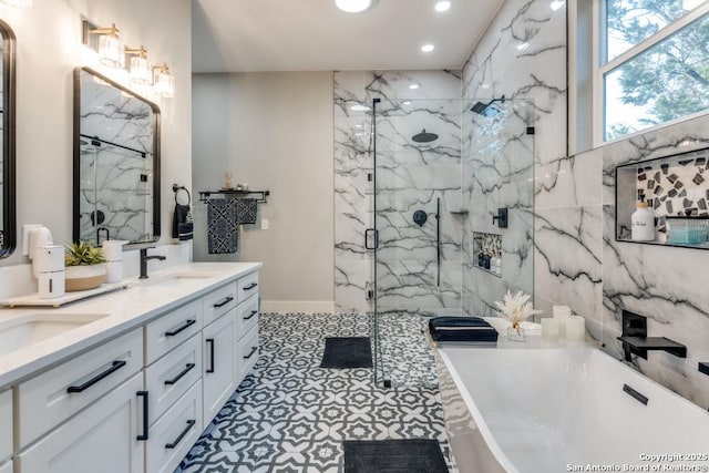 7812 Ventura Blvd, Selma, TX 78154 - bathroom featuring a freestanding bath, a marble finish shower, recessed lighting, double vanity, and baseboards