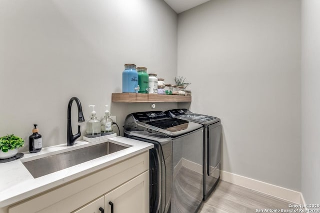 7812 Ventura Blvd, Selma, TX 78154 - laundry room with separate washer and dryer, light wood finished floors, cabinet space, and baseboards