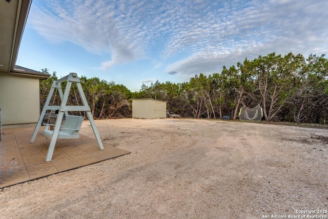 7812 Ventura Blvd, Selma, TX 78154 - view of yard featuring a storage unit, an outbuilding, and a patio area