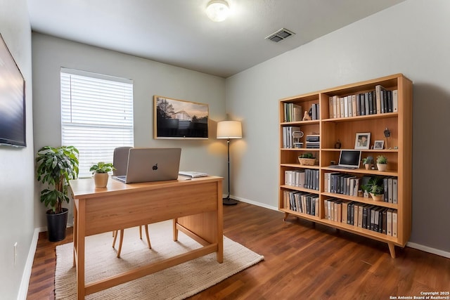 office space with baseboards and wood finished floors