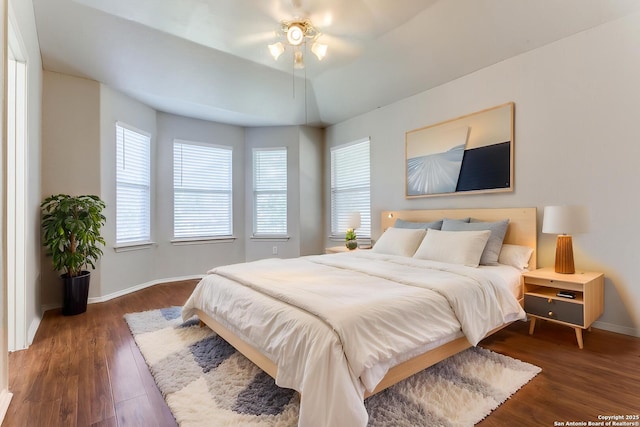 bedroom featuring baseboards and dark wood-style floors