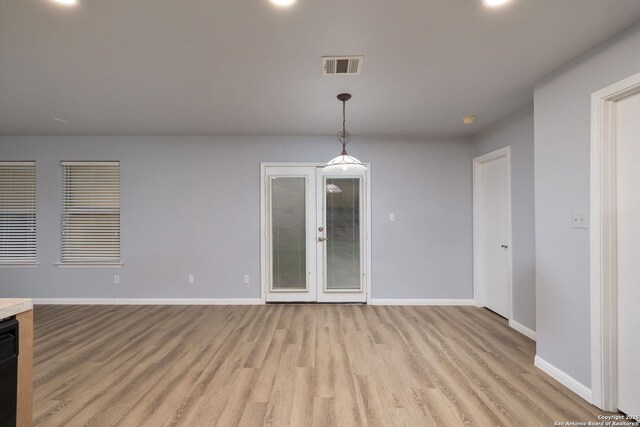 7603 Braun Bnd, San Antonio, TX 78250 - unfurnished dining area featuring light wood-style floors, baseboards, and french doors