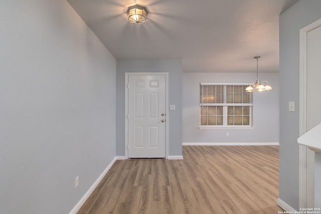 7603 Braun Bnd, San Antonio, TX 78250 - foyer with a chandelier, wood finished floors, and baseboards