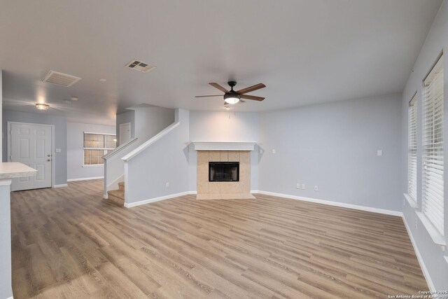 7603 Braun Bnd, San Antonio, TX 78250 - unfurnished living room with a ceiling fan, light wood-type flooring, and baseboards