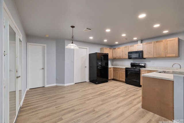 7603 Braun Bnd, San Antonio, TX 78250 - kitchen featuring black appliances, a sink, light brown cabinetry, light countertops, and light wood finished floors