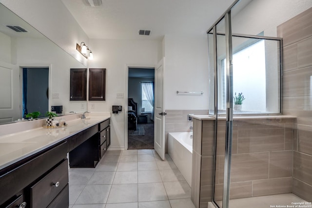 15323 Danae Bnd, San Antonio, TX 78245 - ensuite bathroom featuring a shower stall, double vanity, a garden tub, and tile patterned floors