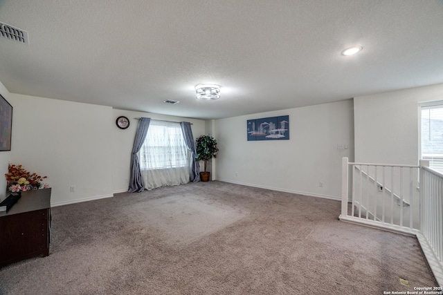 15323 Danae Bnd, San Antonio, TX 78245 - carpeted spare room with a textured ceiling, plenty of natural light, and baseboards