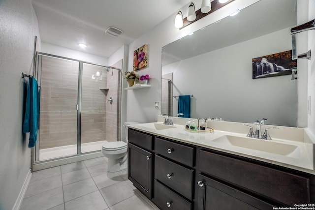 15323 Danae Bnd, San Antonio, TX 78245 - bathroom with tile patterned flooring, a stall shower, toilet, double vanity, and baseboards