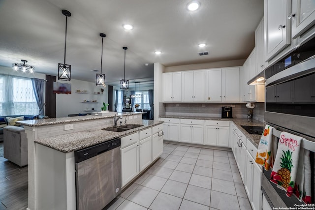 15323 Danae Bnd, San Antonio, TX 78245 - kitchen featuring stainless steel appliances, a sink, open floor plan, backsplash, and recessed lighting