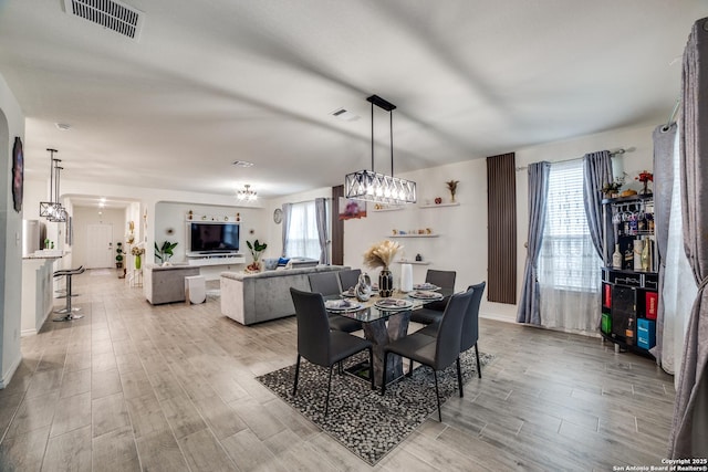 15323 Danae Bnd, San Antonio, TX 78245 - dining space featuring healthy amount of natural light, light wood-style flooring, and arched walkways