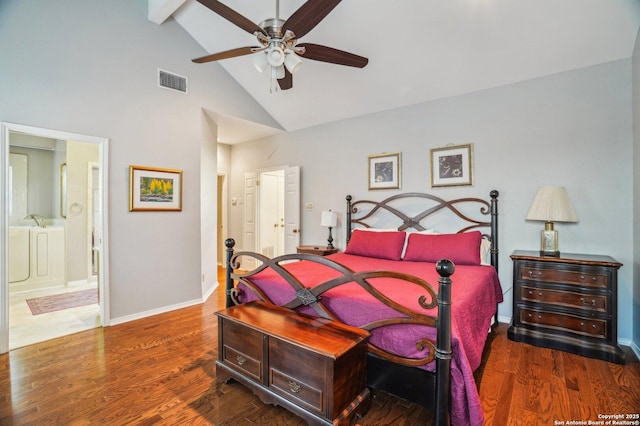 bedroom featuring high vaulted ceiling, beamed ceiling, wood finished floors, baseboards, and connected bathroom