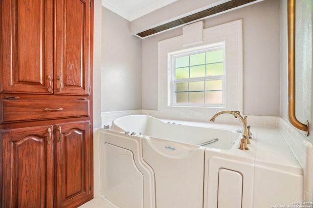 full bath featuring a garden tub and ornamental molding