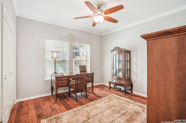 home office with wood finished floors, a ceiling fan, crown molding, and baseboards