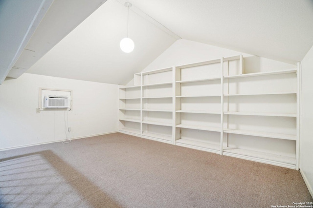 additional living space with carpet flooring, lofted ceiling, and a wall mounted air conditioner