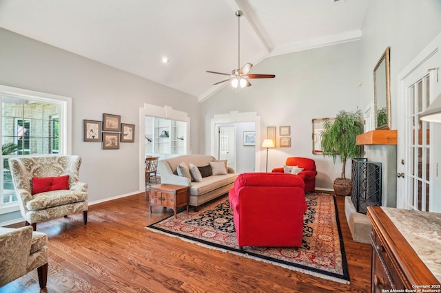 living area featuring wood finished floors, baseboards, a ceiling fan, high vaulted ceiling, and a fireplace