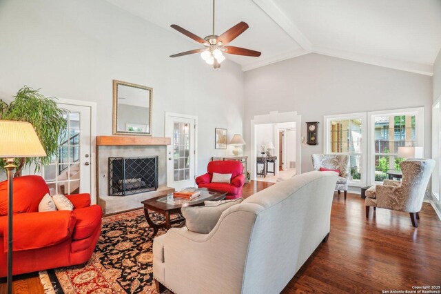 living room with high vaulted ceiling, a premium fireplace, ceiling fan, plenty of natural light, and wood finished floors