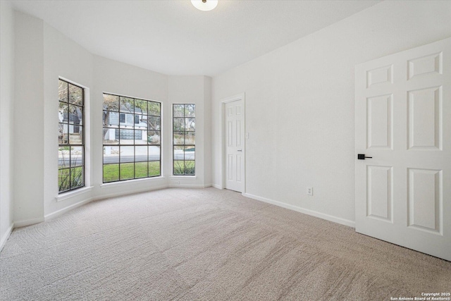carpeted spare room with baseboards
