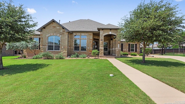 view of front of property with stone siding and a front lawn