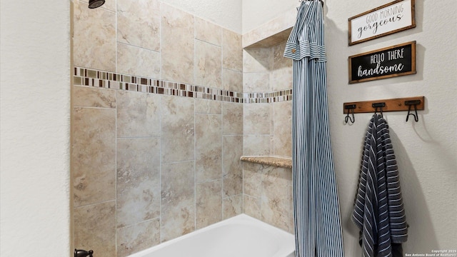 bathroom with shower / tub combination and a textured wall