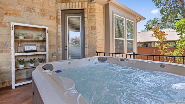 deck featuring a hot tub