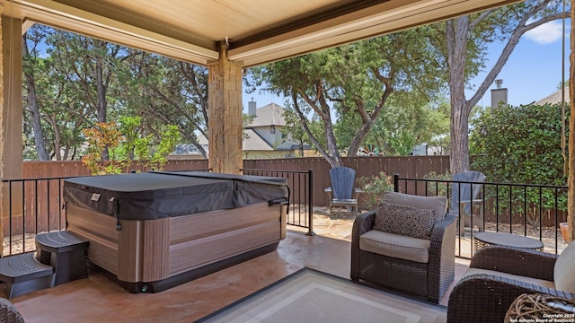 view of patio with a hot tub and a fenced backyard