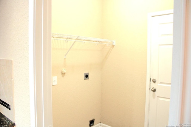 clothes washing area featuring hookup for an electric dryer and baseboards