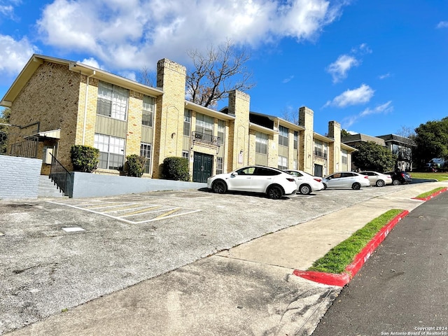 6611 Southpoint Unit 128, San Antonio, TX 78229 - view of building exterior featuring uncovered parking and a residential view