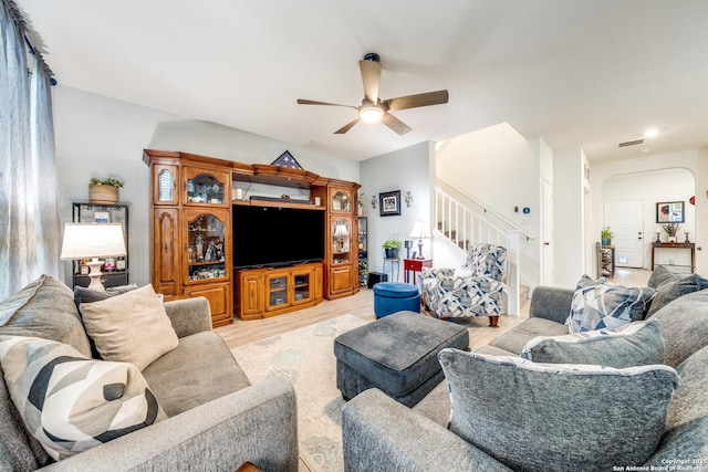 5249 Nature Path, Marion, TX 78124 - living room with a ceiling fan, arched walkways, stairway, and light wood-style floors