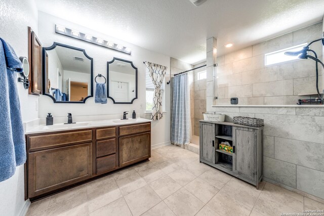 5249 Nature Path, Marion, TX 78124 - bathroom with tiled shower, double vanity, and tile patterned flooring