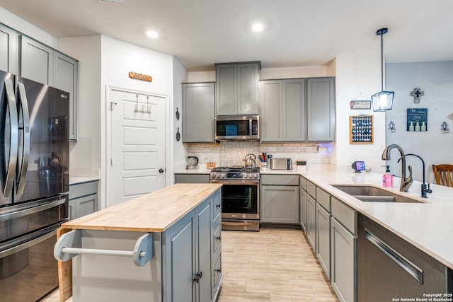 5249 Nature Path, Marion, TX 78124 - kitchen with appliances with stainless steel finishes, wood counters, gray cabinets, a sink, and recessed lighting