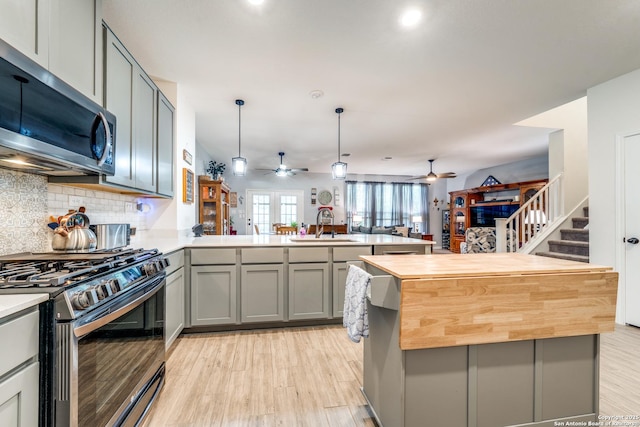 5249 Nature Path, Marion, TX 78124 - kitchen with stainless steel appliances, gray cabinets, ceiling fan, wood counters, and a peninsula