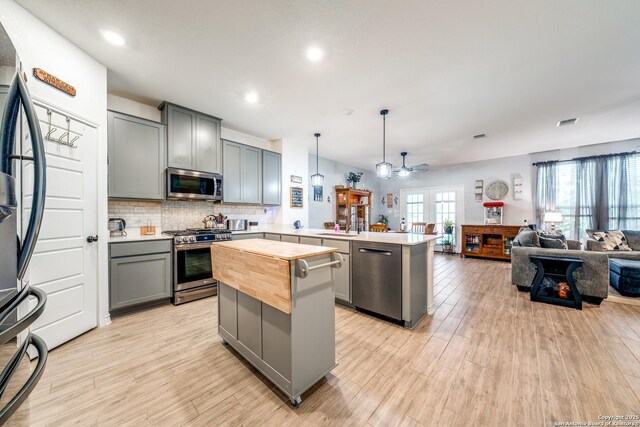 5249 Nature Path, Marion, TX 78124 - kitchen with stainless steel appliances, a peninsula, gray cabinets, ceiling fan, and open floor plan