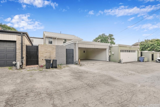 385 Fenwick Dr, Windcrest, TX 78239 - view of property exterior with a gate, brick siding, fence, and a garage