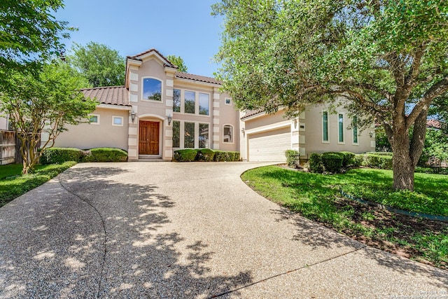 19119 Kristen, San Antonio, TX 78258 - mediterranean / spanish-style home with concrete driveway, stucco siding, a tile roof, and an attached garage