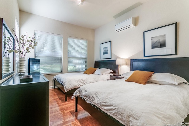 19119 Kristen, San Antonio, TX 78258 - bedroom with a wall mounted air conditioner, wood finished floors, and multiple windows