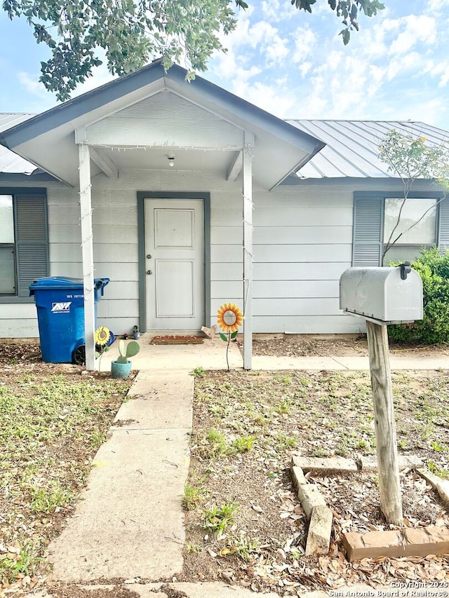 401/403 W Adams, Pleasanton, TX 78064 - view of exterior entry featuring a standing seam roof and metal roof