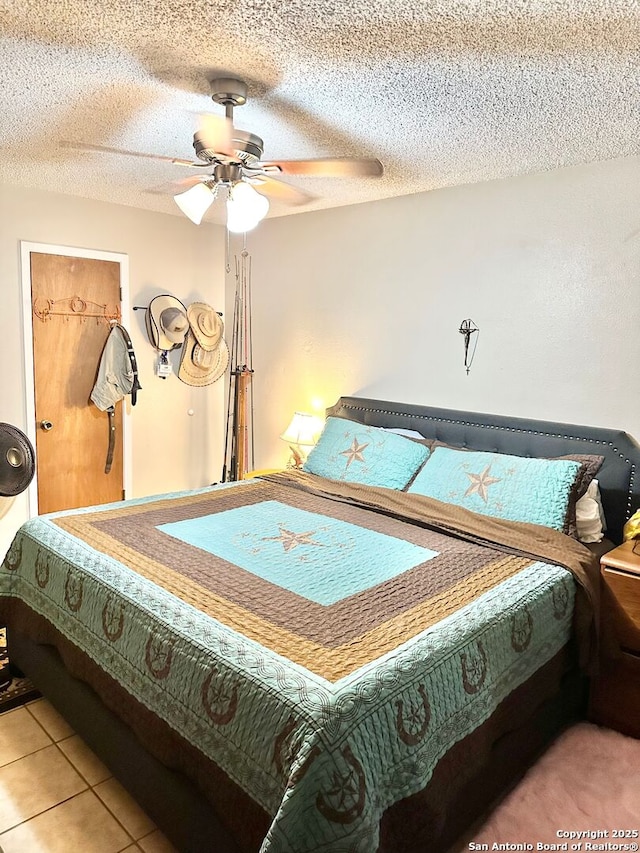 401/403 W Adams, Pleasanton, TX 78064 - bedroom with ceiling fan, a textured ceiling, and light tile patterned flooring