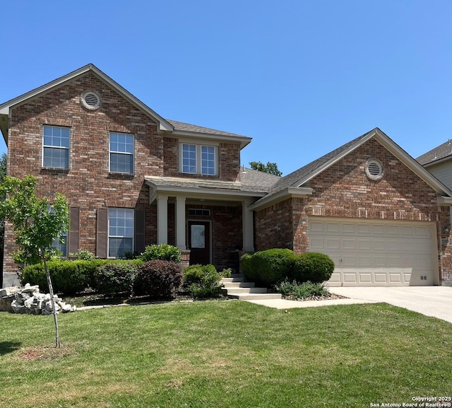 view of front of home featuring brick siding, a front yard, driveway, and a garage