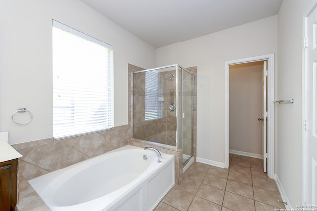 bathroom with a shower stall, a bath, vanity, and tile patterned floors