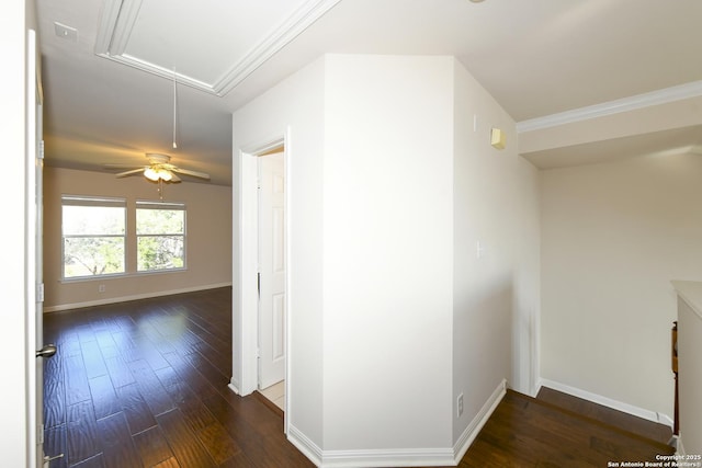 hall featuring attic access, dark wood-style flooring, and baseboards
