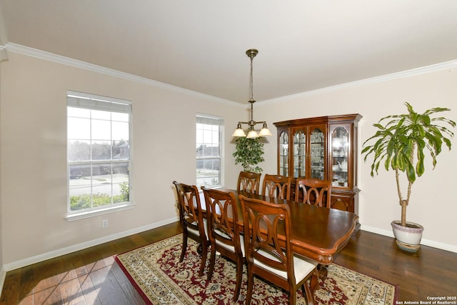 dining room with dark wood-style floors, baseboards, and crown molding
